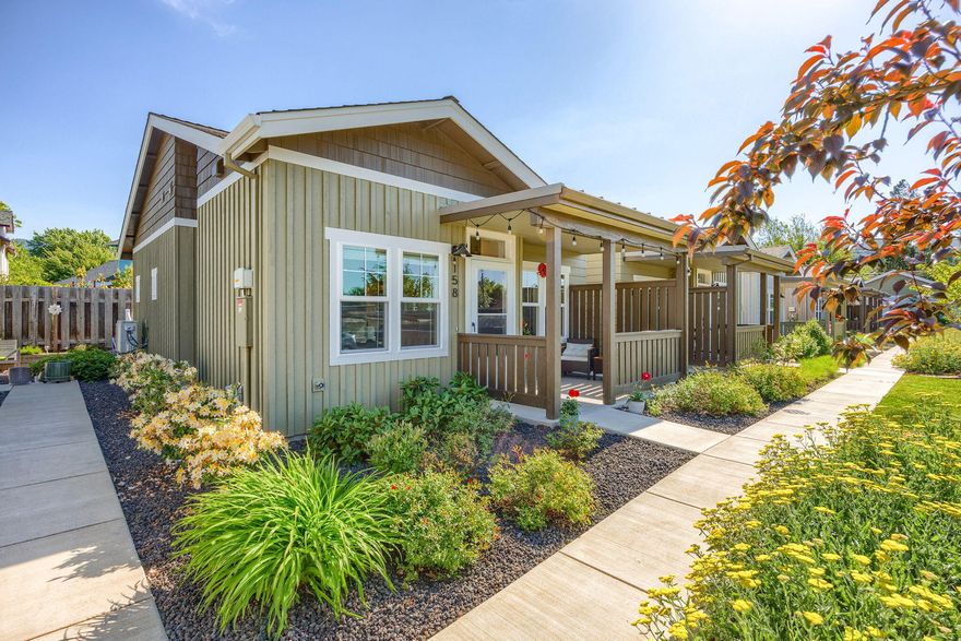 Minimalist living at its best in this eco friendly community. Located in the heart of Ashland, this KDA built home was designed to Earth Advantage Platinum standards, promoting sustainability, efficiency and healthy living. Enjoy the single-level, modern open floor plan, high ceilings and plank flooring throughout. The kitchen boasts quartz countertops and stainless steel appliances. The two bedrooms are spacious, bright and private. This end unit also promotes indoor/outdoor living, with a covered patio in front overlooking the garden and mountains beyond, and a back patio that is perfect for relaxing in the abundant sunlight. The smartly designed interior comes equipped with a large accessible attic storage space. The HOA covers trash and landscaping. Located in a quiet neighborhood that is just blocks from downtown, the dog park, the Bear Creek bike path and Ashlands abundant trails, 158 Mountain View Dr is not to be missed!