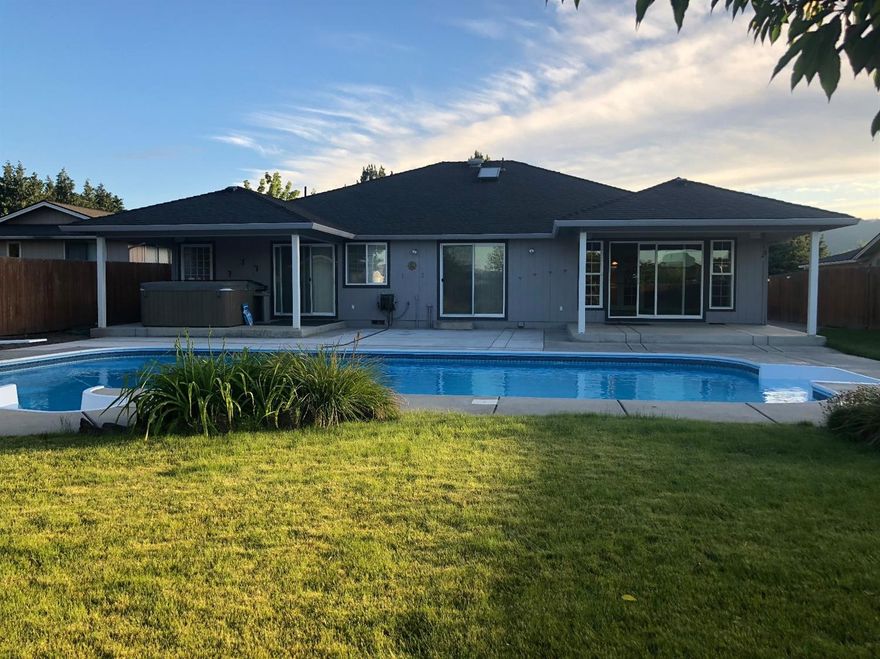 This beautiful home, in the Stonecreek Subdivision, boasts 2484 sqft, 5 bedrooms including 2 masters, 3 full baths, beautiful kitchen with huge granite island, topped off with a in-ground saltwater pool and tranquil backyard! Stepping in the front door you are greeted with gorgeous tile flooring and a kitchen everyone will love, with double ovens, cook top and prep sink in the island and a view out to the backyard. The living room is perfect for entertaining, as it can be set up for many uses and has a large sliding glass door opening to one of the two covered patio areas in the backyard. The front of the home has three bedrooms and two full baths, including a master bedroom. The master suite is the star of the show with walk in closet and both stand in shower as well as a jetted tub in the master bath and it's own sliding glass door to another covered area and hot tub! In addition, the home has RV parking, dog run, and 2 car garage! Call for your tour today