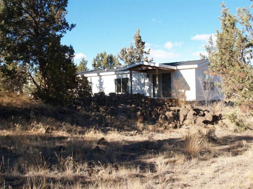 Great location. Nice property with much potential! Almost 3 acres with a 3 bed, 3 bath, 1771 SF home with a master on each end. 31'X20' garage/shop. This property is a gardeners delight with a deer fence surrounding the 80'X65' garden area. The new roof & water heater are a month old. Better hurry on this one!