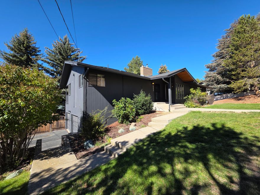 Experience modern luxury and everyday comfort in this stunningly remodeled 4-bedroom, 3-bath home. Step inside to bright, open spaces filled with natural light from brand-new windows throughout. The chef's kitchen is a showstopper, featuring premium stainless steel appliances, Blue Roma Quartzite countertops, and sleek finishes that make every meal an experience. The dining area, framed by windows, opens to a spacious deck with elevated city views—perfect for morning coffee or evening gatherings. The main-floor primary suite offers a cedar walk-in closet and a spa-inspired ensuite with a soaking tub and tiled shower. Downstairs includes a second living room, two additional bedrooms, laundry, and a private sauna to relax and recharge. Outside, enjoy a fully fenced backyard oasis designed for entertaining or peaceful evenings under the stars. Schedule your private showing today and fall in love with this one-of-a-kind home!