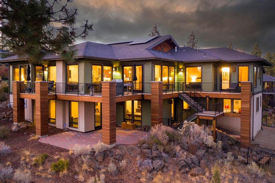 Tucked gracefully on the hillside in a quiet cul-de-sac in Shevlin Ridge, this custom home is at once captivating and contemporary. Rich wood accents flow through the home, lending to a warm yet sophisticated aesthetic. The open floorplan was built for entertaining, and the extensive deck is a haven for outside gatherings or for enjoying your coffee while taking in the forest views. Inside, the chef's kitchen boasts high-end appliances and a beautiful island with a wood breakfast bar. The main-level primary bedroom features its own private deck access & large bathroom w/ double vanities, jetted tub, & beautiful tile walk-in shower. Also on the main level, find a den/office and sunny great room. Two additional bedrooms and bathrooms are downstairs, as well as a large family room with wood stove and wet bar. This stunning Earth Advantage home features rooftop solar and radiant heat flooring, as well as a fenced yard and an incredible 1280 sqft garage. Close to Shevlin Park and schools!