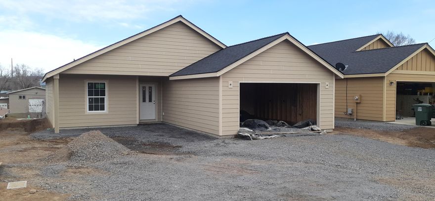 Now under construction, single level home.  1402 Sq Ft, 3 Bedroom, 2 Baths with large open kitchen and living room area. Kitchen island seperates the space with lots of kitchen cabinets. Good size primary bedroom with walk-in closet and bath.  Seperate utility room with lots of storage. Heat pump for heating and cooling. Sheetrocked garage. Convenient west side location.  Still time to pick colors for counter tops and paint! Projected completion by June.