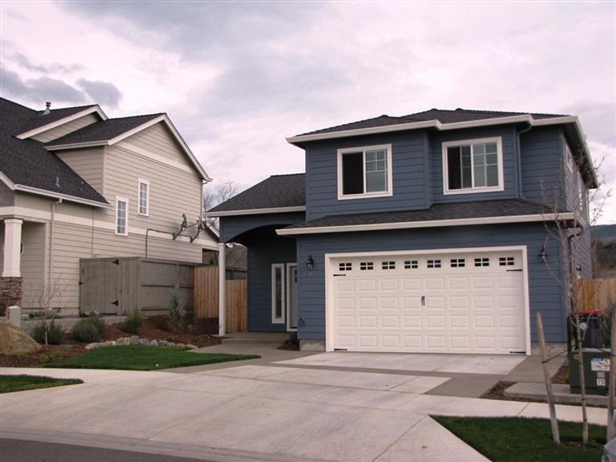 Built in 2013 by a contractor focused on the details with a great reputation. This meticulous home features many upgrades including granite counters, custom cabinets, stainless steel appliances, and large pantry. Main level living/great room and kitchen have beautiful laminate and tile flooring, while upper level has plush carpet for comfort. Views of Roxy Ann, low maintenance landscape. And conveniently located in a the subdivision across from the Albertson's Center with shopping, a variety of restaurants, near golf courses, and close to Rogue Valley Medical Center.