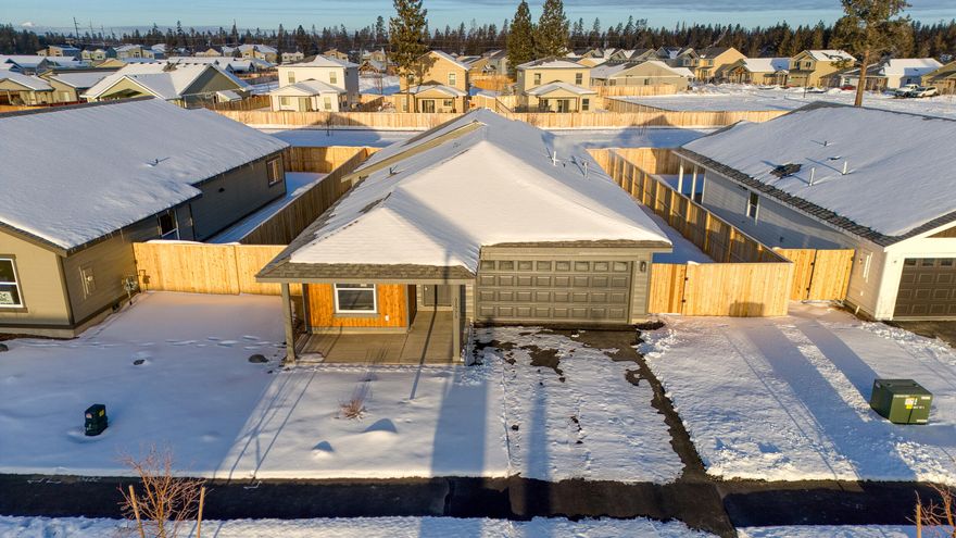 Looking for a permanent residence or an investment property? This could be it! This contemporary NW style home built in 2024 offers a well-thought-out floor plan with 3 bedrooms, 2 full bathrooms plus an office/flex space and 1594 square feet of living space. Located in the Reserve in the Pines Development, this home boasts vaulted ceilings with a lot of natural light. Large great room with a kitchen that has a functional, sleek kitchen with modern touches. Features of the home include: a large kitchen island with quartz countertops, gas range, subway tile backsplash, soft close cabinets with ample storage, stainless steel appliances, large pantry, LV flooring, large laundry room with a barn door and double cabinets. Bathrooms are spacious with quartz counter tops, the primary includes a double vanity. The yard is fully fenced and gated with a concrete covered patio, great for entertaining. This development is close to city center, schools, shopping, healthcare, and more