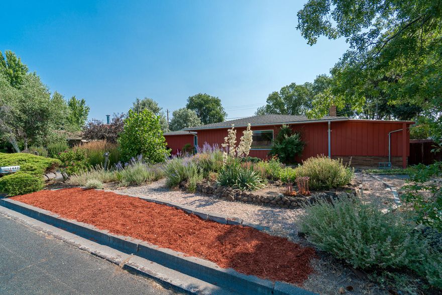 Mid century modern charm w/Cascade Mtn Views! Inspired by Frank Lloyd Wright, this prairie style home is low profile & linear in design w/gardens that are sure to please. 3 bedroom, 2 bath home w/plenty of space for entertaining indoors & out. Views of the Cascades from the living room & front gardens. Enter from the street into a private, fenced courtyard where morning coffee can be enjoyed & kids can play. Mudroom style entry w/farm house charm leads to an open living space w/sleek electric fireplace, bamboo floors & adjoining kitchen. Plenty of counter space & room to prep on butcher block counters, SS appliances & cabinet hardware.  Attached sun room off of the dining & living area makes for a great plant room or opportunity for passive solar. Bedrooms & baths are over sized w/built in cabinets & drawers. Well kept home has a newer roof, windows, doors & heating system. Alley access single car garage/workshop area, additional driveway parking & space for RV too! A/C, gas forc. air.
