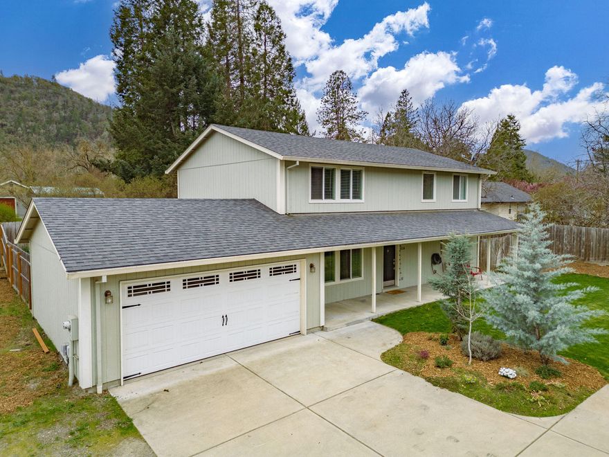 This charming two-story home is ideally located close to the beautiful Rogue River and boasts a spacious living room, dining area and a separate family room for comfortable living. The kitchen has been recently updated with newly painted cabinets and features glass sliding doors leading to an outdoor terrace, perfect for enjoying the surrounding natural beauty. The main level has also been refreshed with new flooring and a fresh coat of paint. For added comfort, the home now includes a new central heating and air conditioning system. Upstairs, you'll find the master bedroom and three additional bedrooms, including a large fourth bedroom that could serve as an additional office or guest room. The property is fully fenced with underground sprinklers and RV parking, making it a perfect choice for families looking to enjoy all the nearby river activities, such as fishing, boating, and swimming, year-round.