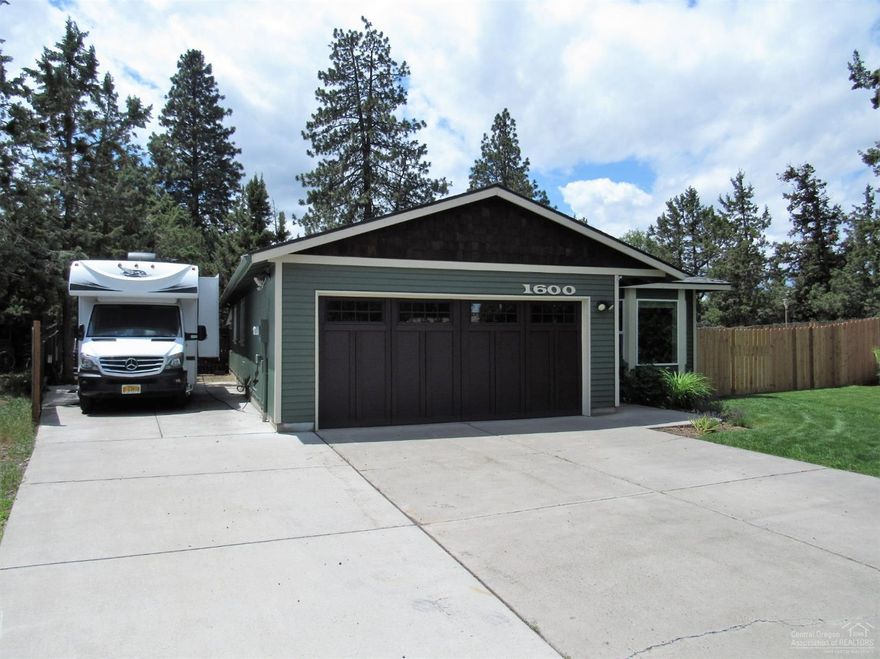 This single level home with large lot is a rare find . Meticulously updated inside and out it has a contemporary feel. The spacious kitchen features all new cabinetry and solid surface counter tops. There's tons of room for preparation or entertaining and endless amounts of storage. Need RV parking? No problem and its paved! There's also a finished, heated outbuilding perfect for a studio or office. This home includes plans for expansion, pre wiring for ductless heat pump, heated garage, and more. Located close to parks, eateries/Breweries, and has quick access to the Bend Parkway. This one needs to be seen.