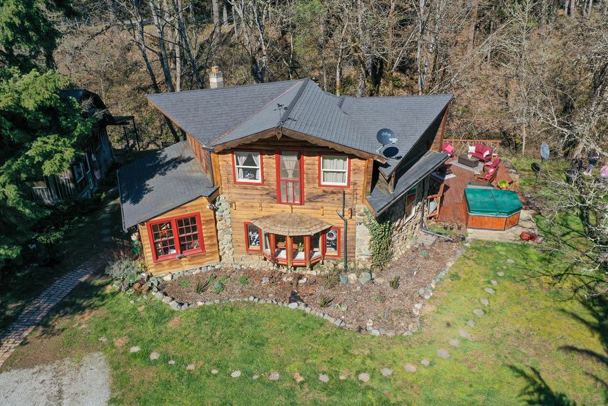 Beauty & privacy abound on this gorgeous property on Quartz Creek Road. Featuring 2 homes that sit right on the creek w/ lovely water sounds & swimming holes.  This 10 acre parcel has approximately 2 level acres & sits way off the road w/privacy & character. Relax right along the creeks edge from either the deck, or around the fire pit. The artistic 1160sq.ft. main home with rustic flair features thick 12' walls, high ceilings, stone fireplace with a certified wood stove, central electric heat & air, plus a nice kitchen with island, & beautiful bay window to sit & read a book in the dining area.  Upstairs you will find a bedroom, bathroom w/tub-shower combo, & walk in closet. The gorgeous mountain views from the deck will take your breath away! The additional dwelling unit features 2 bedrooms, 1 bath, kitchen, living area & woodstove. There is a spring fed pond, classy chicken house with hardwood floors & quaint architecture, an oversized pump house, & a great shop with mezzanine.