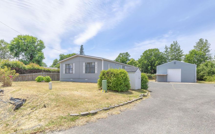 Fresh and updated 2 bedroom, 2 bath Manufactured Home on almost 1/3 of an acre with a huge shop!  Move in ready with New Carpet and Interior Paint in 2024, updated Plumbing Supply Lines in 2020, and a new Roof, Exterior Paint, and Mini-Split HVAC System in 2019.  Spacious Eat-in Kitchen, Large Primary Bedroom with Walk-In Closet, and Laundry/Mudroom. The shop is app 1200 sf and includes a ½ bath (was a full bath but owner removed the shower/tub combo, plumbing still in place but capped), a large finished ''office'' space, and a roll-up door. Property is level with paved driveway/parking and a cement RV Pad. In 2018 well tested at 16gpm. Public sewer. Close to Town, Hospital, RCC, and the beautiful Rogue River.