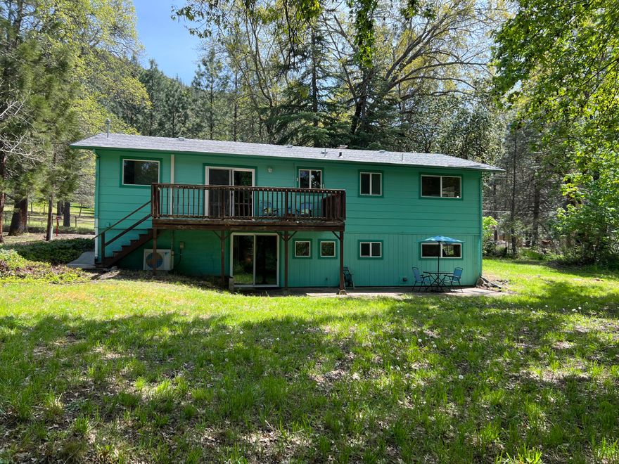 Don't Miss this Hidden Gem - Located in Rogue River nestled in between Medford and Grants Pass, Oregon.  This 1960 sqft home sits on 1.34 acres with Wards Creek frontage.  Main level  you have 2 bedrooms, 1 bathroom, living room with a wood burning fireplace, kitchen/dining with access to the upper deck, perfect for summer BBQ's. Downstairs you have an additional 2 bedrooms, 1 bathroom, an over-sized family room and a second wood burning fireplace.  This park-like setting has plenty of room for all your outdoor entertaining, room for volleyball, corn hole, outdoor fire pits, and all your gardening needs.  Add a shop for the toys - The possibilities are endless.  Mature Oak and Maple trees provide the perfect amount of summer shade, fruit trees include Apple, Plum, and Walnut.  Newer ductless heating and air, with several other improvements made in Sept. 2021.  Rural living, near Salmon Fishing, White Water Rafting, and Rugged Scenery -less than 5 minutes to I-5