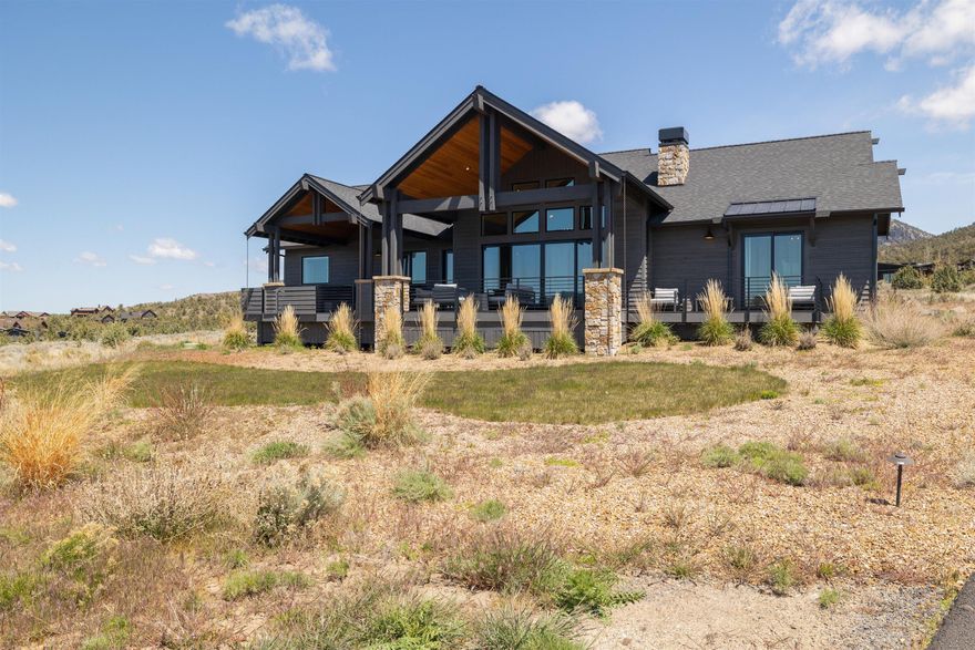 Beautiful one-level home with Cascade Mountain views and an ideal location close to amenities. The exterior features stained wood siding and extensive stone accents. This home has a commanding sense of arrival as you enter the foyer with vaulted ceilings and warmth with sunlight through the expansive windows. It is ideal for the entertainer with a large great room featuring a stone fireplace, dining room, and beautiful kitchen. The kitchen features stainless steel appliances, walk-in pantry, and a spacious island, perfect for the home chef. The primary bedroom is an oasis with a walk-in closet, soaking tub, and patio access. There is also a den ideal for an office or bedroom, two additional bedrooms, full sized bathroom and a utility room. Outside on the large deck, you can catch the sunsets while entertaining guests or relax in the hot tub. An oversized three bay garage finishes the home.