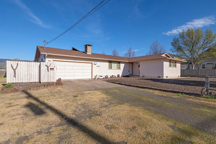 First time on the market in almost 30 years! Come view this well taken care of three-bedroom, two-bathroom home sitting on over a 1/3 of an acre in Ashland! In the home you will find a nice sized living room with wood-burning fireplace to keep you cozy. The spacious kitchen comes complete with a breakfast bar and lots of counter space. There is a primary bedroom with attached full bathroom and two more additional bedrooms down the hall. Step out onto the enclosed patio which provides a great entertaining space with lots of natural light. In addition to the two-car attached garage you will find an additional two-car garage behind the home. The backyard is ready for your fresh ideas with lots of space for gardens and hobbies. This property even has TID irrigation rights! Call today for an appointment!