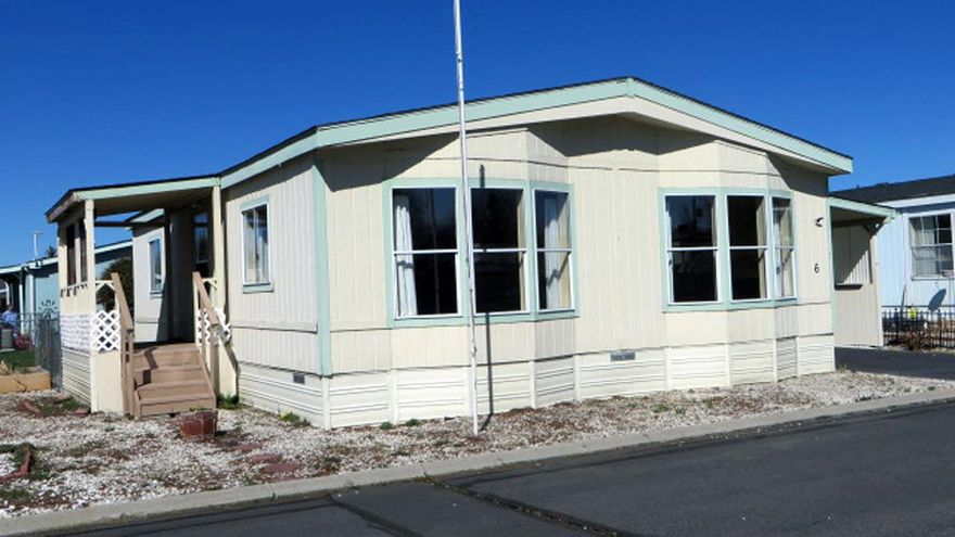 Here's a great buy in the desirable Alpine Meadows Mobile Home Park! (This park is a 55 and older park). This is a 2 bedroom, 1 bath home in move-in condition. It has central forced-air heat and air conditioning. The carpets have just been replaced and the roof was replaced last year (2019). There are two storage buildings, one at the end of the enclosed carport, and the other in the fenced back yard. The space rent is $378 per month which includes water, sewer, garbage and snow removal. The park club house is just down the street. There is an area for RV parking (check on availability) and an overflow parking area.