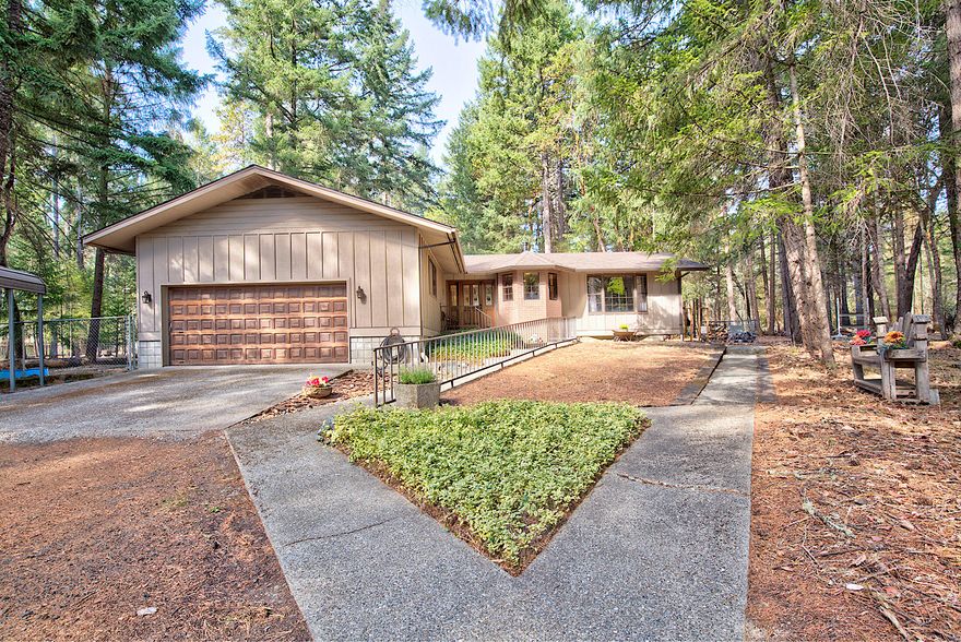 Tucked back amongst the trees on a quiet country road, sits this beautiful custom home on 2.86 acres. Gated and partially fenced with an insulated 1230 sq ft shop that has a 14 ft door, engine hoist, bathroom, plumbed for air tools and tons of storage space. There is also covered RV parking, horse stalls, round pen and chicken coop. The home boasts of gorgeous hardwood floors and unique wood accents on the walls and ceilings throughout. The kitchen has been recently remodeled with concrete countertops, ash cabinetry and an island with breakfast bar. The bathrooms have been updated with concrete countertops, showers and floors. The split floor plan and vaulted ceilings create great space with a cozy feel. The homes foundation was built to accommodate a 2nd story if so desired. This is an amazing property for horses, livestock, gardening or just enjoying nature and the wildlife up close and personal. Come tour this serene and peaceful hideaway today!