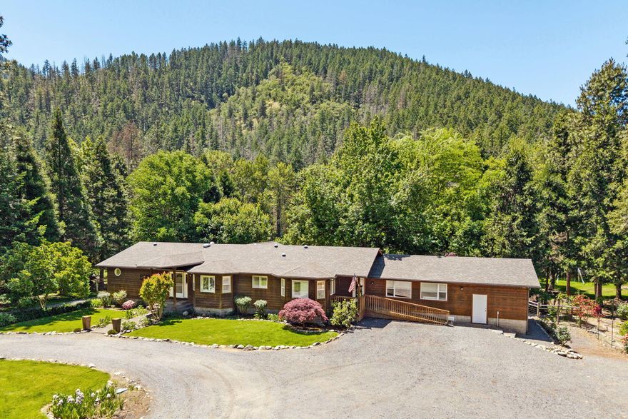 Amazing Applegate River frontage for fishing, kayaking, or tubing w/private park-like grounds to enjoy the serenity on your 3.89 Acres w/water rights from the river. Single level home w/many upgrades throughout including interior paint, exterior staining. Open Kitchen w/granite counters, DBL ovens, 5 burner gas cooktop, eating bar & Refrigerator included. Primary Bathroom w/new updates to include: tile shower, lg Walkin closet, slider to deck overlooking the river. 4-bedroom w/split floor plan, media/bonus room, hardwood floors. Separate Studio area, oversized finished & insulated 2 car garage w/ storage. New roof just added. Trees, gardens, chicken coop, hay barn, fruit trees & pasture for animals. Centrally located between Grants Pass and Medford in the middle of the Southern Oregon Wine Country.