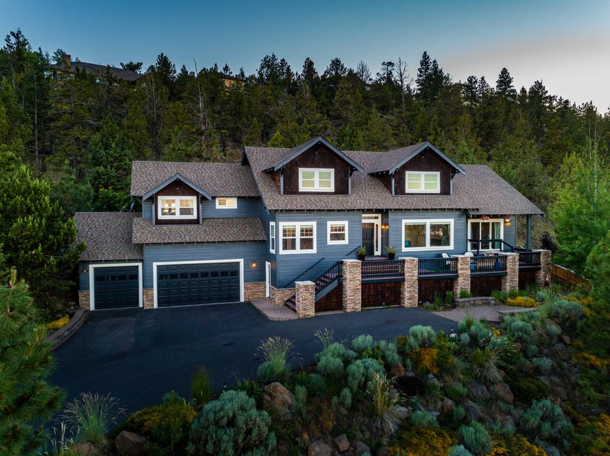 Panoramic views from nearly every room in this house! From Smith Rock, to the Ochoco's to Paulina Peak these views are simply amazing!!  Situated on a private 1/2 acre lot & perched above Colonial Drive, this NW Craftsman impresses immediately with a spacious living room including vaulted ceilings, a new floor to ceiling stone tiled high-end fireplace, and dual zone surround sound. Gleaming hardwood floors, wainscoting, & open staircase give this home that craftsman character. The kitchen features granite counters, island, stainless appliances & custom cabinetry. Main level master suite with fireplace, spacious bath and walk-in closet. Upstairs includes the loft bonus space & 3 additional bedrooms. The 4th bedroom could be the perfect work at home office which is secluded with a private entrance. Plenty of parking & storage with huge 3 car garage. Enjoy the sunrise/sunsets from the private deck & patio areas. Fresh exterior paint, new bathroom fixtures, water heater & more