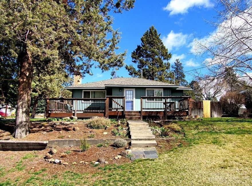 Turn key cottage on huge corner lot in Midtown. All the charm you expect including hardwood floors, wood burning fireplace, amazing yard and detached garage. This home features updates throughout: new roof, new windows, updated kitchen and bath. Huge deck where you an watch the sun set over Mount Bachelor. Oversized corner lot with fruit trees, garden area and dozens of bulbs just starting to peek up. Energy efficient updates include tankless water heater.
