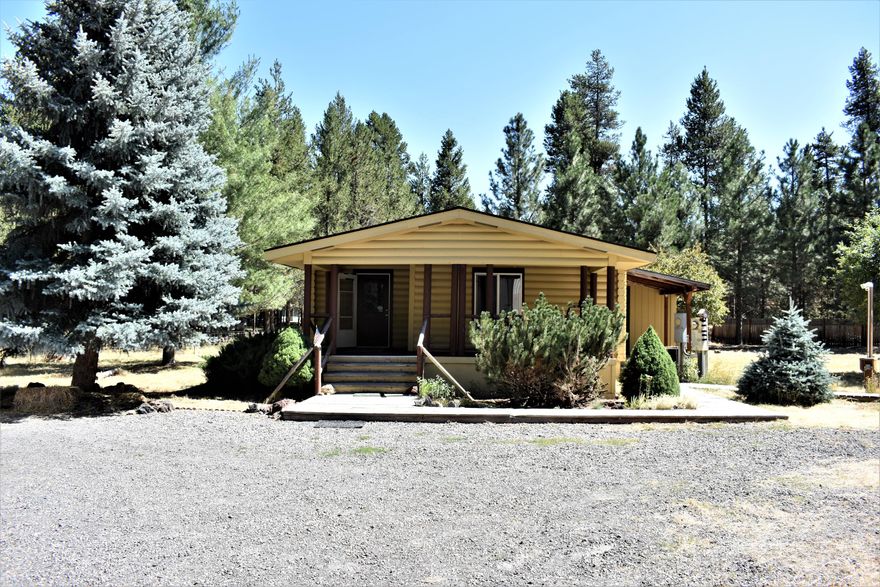 A wonderful .93 acre property to call your own! Come check out this 1,015 sq ft 2 bed 2 bath 1990 Manufactured home that has plenty of space! Nice sized kitchen with a lot of cabinets and island that has a fresh butcher block top. Open concept with a great floor plan. Home had a new roof installed in spring of 2022!  Property includes a spacious 1,280 shop with concrete flooring, large workshop, large RV garage door and one single car door. A second shop; 824sqft with concrete floors attached to 288sqft of more shop space!  This is a great opportunity to own a property that is fully fenced and gated, space for animals, toys and more! The green house has running water and power to grow all your favorite vegetables! Home has electric forced air heating/cooling and wood stove heating! Great central location, paved road and easy access to Burgess Road and Hwy 97! 15 minutes to Sunriver and 30 minutes to Bend!