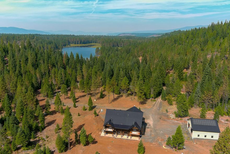 Exceptional off-grid estate on 160+ acres with a private 64-acre stocked pond, abundant wildlife, and stunning mountain views. The 6 bed, 6 bath custom home is nearly complete and features two master suites with balconies, a theater, wine room, gym, and safe room. Multiple wood stoves throughout the home create a cozy retreat. Designed for self-sufficiency and year-round enjoyment, with a full solar power system and generator backup. The pond is stocked by ODFW with rainbow trout 4x/year and supports bass, bluegill, and crappie. World-class fishing, hiking, riding, and hunting are all nearby, with 2 LOP tags included. Just 30 min to Crater Lake and under an hour to the airport—an ideal legacy property or private retreat.