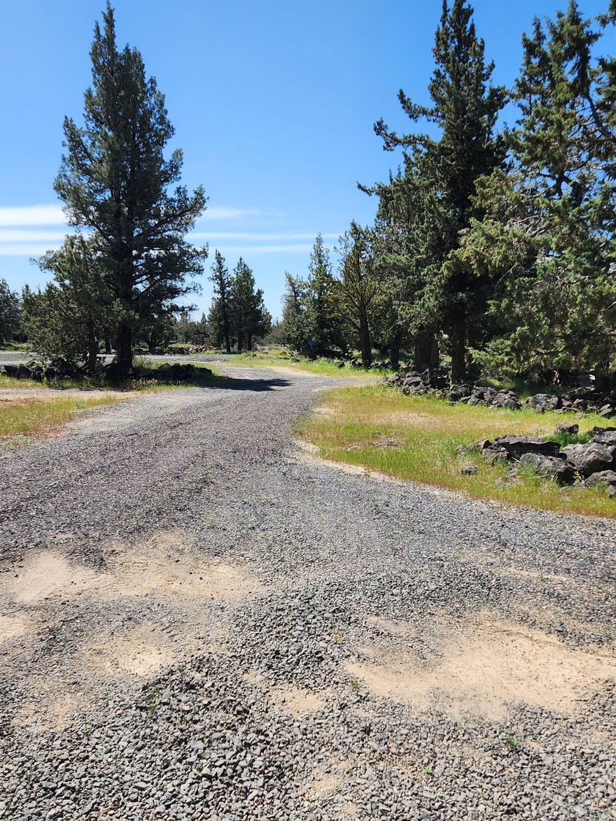 Buildable lot inside 3 Rivers Rec at end of cul-de-sac  .70 of an acre with large circular graveled driveway. Several bump out areas for trailer or car parking. Outhouse, storage shed, 1300 gallon cistern, 500 gallon propane tank rental from Ed Staub & much more. Huge asset is the 20'w X 26'd X 14'h 3-sided enclosed carport for toy storage. What a way to get property inside 3 Rivers in order to enjoy all the amenities: private access to Lake Billy Chinook, private beach area, pickleball courts, 18 hole disc & 9 hole desert golf course, Event Center,  Rec Hall, 2500 ft.  paved airstrip OG00, high-end shooting range & much more. Don't miss this opportunity---call an agent today to book a showing.