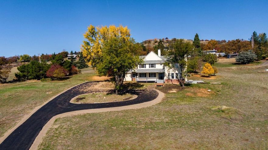 A little bit of country close to shopping, hospitals & great restaurants. 1.93 acres with views of the valley, Mt. Ashland and city lights. Newly paved driveway! Covered front porch. High ceilings, lots of windows to bring in the natural light in the large living room with fireplace, French doors to a side patio area. Large formal family room with sink & built-in book cases & wet bar, hardwood floors & wainscoting. Large kitchen with new granite counter tops, island with electric cook top, breakfast nook with slider to backyard. Master bedroom with wood stove, lots of windows, dbl sinks & soaking tub. 2 large guest bedrooms.