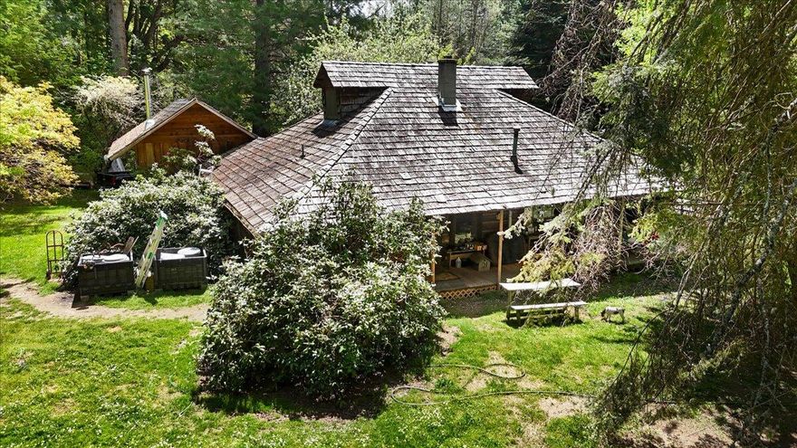 Charming Log Home on 16 Acres - Perfect Country RetreatEscape to your own private paradise with this beautiful log home set on 16 wooded, fully fenced and cross-fenced acres. The spacious master suite includes a loft, walk-in closet, and private bathroom, offering a cozy yet open retreat. Enjoy peaceful mornings and serene sunsets from the large covered wrap-around deck—ideal for entertaining or relaxing.Inside, the home features rustic charm and solid craftsmanship, with a wood stove for cozy winters and high-speed internet for modern convenience. Though it could use some updating, the potential is truly inspiring.The land is a dream for hobby farmers or nature lovers, with three horse stalls, a chicken coop, duck house, wood shed, pond, and a year-round creek. The property includes pear, apple, plum, and walnut trees, and there's a sunny spot just right for a garden. Call for your tour before its gone!