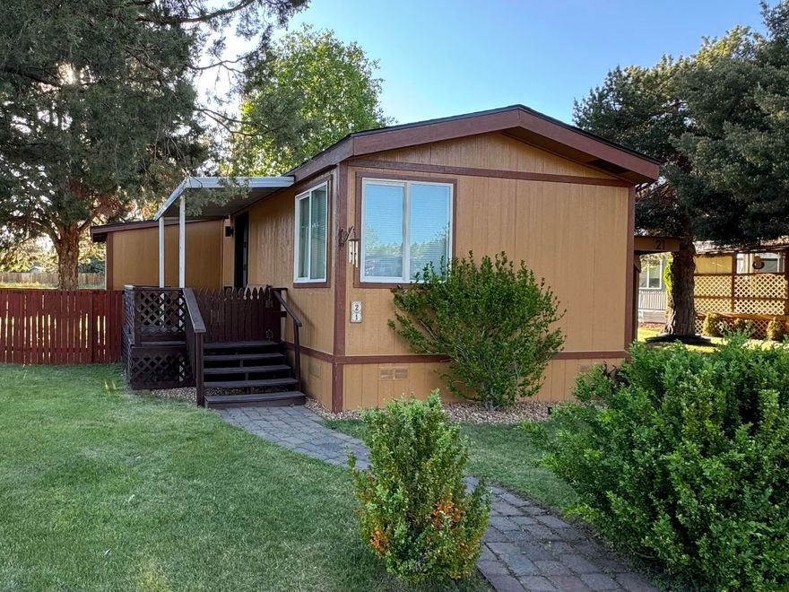 This wonderful, bright, and contemporary manufactured home is a rare find with two bedrooms and an office.  With extensive interior renovations, serene location, and proximity to the vibrant Reed South development, this home offers the perfect blend of comfort, convenience, and modern living.  Whether you are looking for a peaceful retreat or a place to entertain this home has it all. Fully fenced yard, mature landscaping, and a covered front porch provides the sought after indoor/outdoor lifestyle.  This gem of a property underwent extensive renovations and upgrades in 2022: New electric stove, carpet in bedrooms, vinyl plank flooring, modern window and door trims, matching hardware throughout, contemporary window coverings, black out blinds in the bedrooms, electronically controlled blinds in the primary bedroom, and the list goes on.  See attached list for additional upgrades.  Large storage shed adjacent to carport.  Monthly space rent includes water, sewer, street snow removal