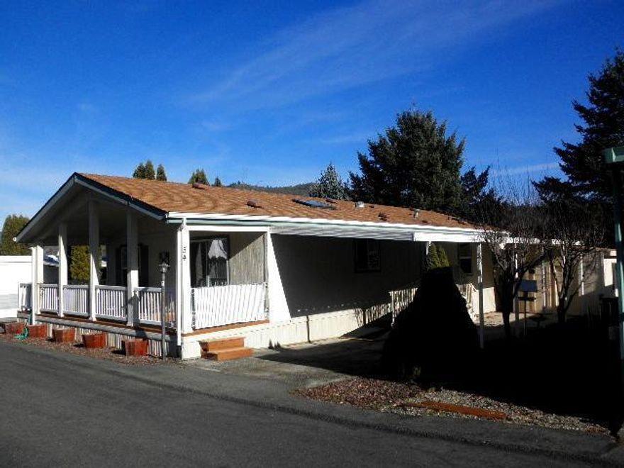 Beautifully maintained home that is sunshine fresh inside and out. Move-in ready with many special features for you to enjoy. You will love the vaulted ceilings, spacious living room, fans, & windows with pleasing views. Appealing floor plan includes charming kitchen with island. The large wrap around Trex decking is easily maintained. You'll be delighted you found this special home.