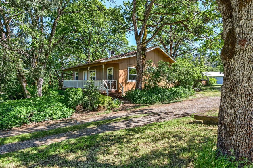1st time on the market! Nice, flat rolling 4 acres with trees & fruit trees. New electric gated entry, all fenced with shop/barn, shop room, separate office/hobby rm. Are you looking for extra area room for family? Dbl doors off the back of the home where laundry rm is with large guest area w/full bath & oak cabinets w/ counters for a mini kitchen setup or 2nd primary suite (extra bedroom) w/covered deck. Vaulted ceilings in Great Room & dining rm w/wood burning fireplace. Open kitchen w/eating bar, office/ bdrm w/ French Doors. Laminate floors throughout except for bathroom; NO Carpet! Lg covered porch in front & deck off sliders. 3 animal kennels plus a free-standing doghouse. 2 wells on the property, one for the house & one for watering the yard. Located in an area of nice homes on Old Stage Rd.  Seller will credit $30,000 to Buyer at Closing for Closing Costs or Buy-downs or updating.