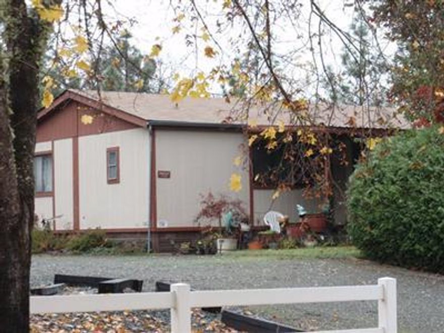 This nice doublewide mfg home is located in a small country set community of like homes just a short drive from Grants Pass. In this neighborhood of 55 plus, the home sits on a rented lot with a large yard, garage, porch, and a new roof. There are two bedrooms, two baths, a laundry room, and spacious living room/kitchen area. Owner will have carpets cleaned.