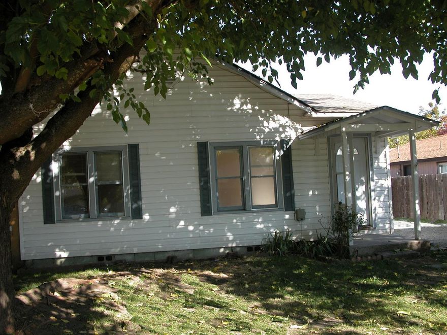 Cute cottage style home in move-in condition with some updates. Newer laminate floor in living room and kitchen. Original hardwood floors in bedrooms. Newer HVAC system which is dual gas/heat pump, newer water heater, some newer windows. Nice size living room. Great kitchen with gas range/oven with adjacent sunny dining area. There's also a large utility/mudroom with storage. Both the front and back yards are spacious and fenced. Conveniently located just a block from Washington School.