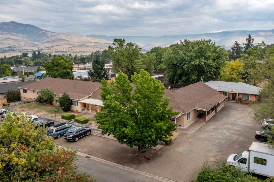 Rare Offering! Single level 12 plex Ashland property on large & level, 1.2-acre parcel with room for additional development. Great location near SOU, YMCA, shopping, restaurants & bus line. Well maintained with many upgrades. Attractive interiors for these uniquely sized apartments which include studios, 1-, 2- & 3-bedroom units plus a detached 3-bedroom house. Nice expansive outdoor spaces with covered porches, 3 large, covered patios, lawn area, views of the mountains. Two large parking areas. Separate fenced area for development for a possible 5 additional units. Please do own due diligence with City. Recent upgrades include plumbing, electrical, all new appliances in unit 7 including mini-split HVAC. New color-in stucco on main building, over 40 new double-glazed argon-gas vinyl windows, recent paint. Many previous upgrades include cabinets, flooring & appliances. Financials provided with signed Non-Disclosure. Possible owner-carry with large down.