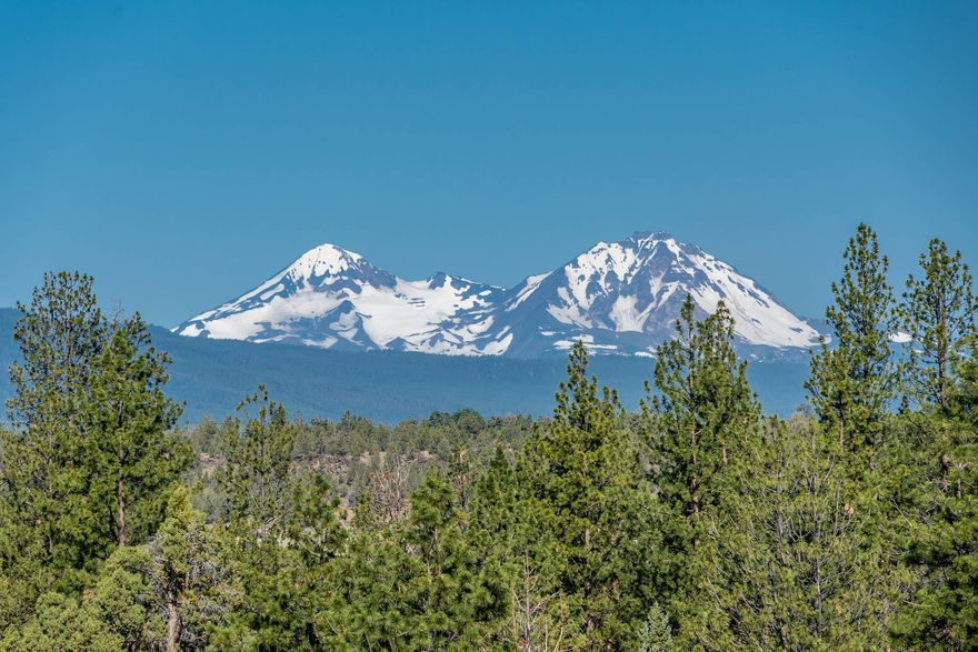 If you have been searching for one of the best locations in Bend - look no further!  Experience the ultimate in privacy and laid-back living with this stunning 1.5-acre property. From almost every room in the house, soak in the breathtaking views of the Cascade mountains. Located on a peaceful cul-de-sac with northwest sun exposure, this home offers the perfect retreat to unwind and relax. Despite being perched on the edge of a canyon overlooking the Deschutes River, the driveway is gently sloped, making winter access easy.

The main level of the home boasts a primary suite, an office/secondary suite, a living room, a gourmet kitchen, two half baths, a laundry/mud room, and an indoor lap pool. Head downstairs via the elevator to discover three more bedrooms, a bonus room, and ample storage space. Take a dip in the 46 ft long lap pool or hop on a bike and explore the Deschutes River Trail leading to downtown Bend.

Don't miss out on the chance to own a prime location in Bend.