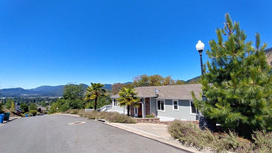 Majestic home just like the Hollywood Hills in California with complimentary Palm trees! City and valley views in your backyard or from your deck. This home is at the top of the prestigious Panoramic Loop Estate homes. It has all the living area on the main floor with bonus living area downstairs. Master Bedroom on main floor, living room with open kitchen, includes views out every window. Wrap around decks and BBQ areas are all around. Downstairs is perfect for entertaining with one bedroom that is being used as a movie room and then you have a family room with two more bedrooms, Full Bath and a den area. This would be a great two family setup. Special Engineering and custom appeal went into this lovely home just south of Grants Pass with Panoramic views for which the street is named. Experience the beauty of living in this elegant but spacious home today. All information deemed accurate but not guaranteed and subject to change at any time.