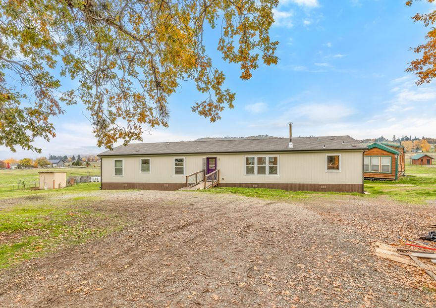Come experience this little slice of southern Oregon heaven! Enjoy the amazing views of the Table Rocks while having elbow room and solitude. With 5.14 acres at your disposal, there is plenty of room for livestock in the fenced pasture and a garden large enough to feed your family all year. Southern Oregon is one of the best places for fruit trees and this property already has apple, pear, nectarine, plum and raspberries planted. The 2018 manufactured home is in great condition with ample space of 2,052 sq ft, 4 bedrooms and 2 bathrooms. Both the well and septic are recently installed. This property is easy to show, schedule a tour today!