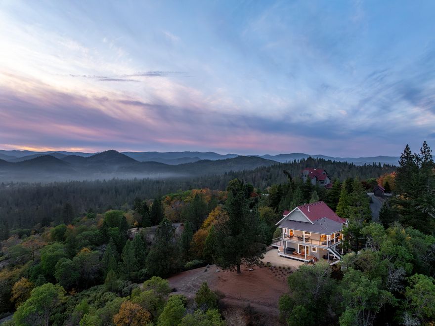 This stunning property offers a serene retreat w/exquisite living spaces & custom amenities w/awe-inspiring vws. Evenings come alive under a canopy of star-filled skies, creating a magical setting. Gated, paved drive escorts you to this private mtn estate. This home is timelessly designed for prime entertaining. Where Typical is replaced by fine Craftsmanship in all details that award this artful 2 story, 3 bdm (primary & spa suite downstairs), 4 ba hm. Amazing wood ceilings greet you to an open floorplan that seamlessly connects the LR, dining area & to the dream kitchen that will awaken your culinary senses w/chef's quality stainless-steel appl & a unique island. You'll want to spend hours on the open covered balcony w/an outdoor kitchen that surrounds the south upper level. Take the inviting staircase & descend to the courtyard-fountain area to a covered patio surrounded by the beautiful landscape. All this, just min to S Grants Pass amenities & the Applegate Valley Wine Country.