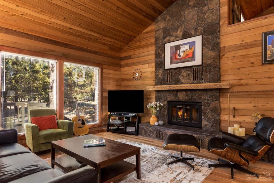 Classic Sunriver home has four bedrooms, three bathrooms and a loft. You don't want to miss this Sunriver GEM! Perfectly located on a corner lot, surrounded by common areas, this home is very convenient to the SHARC; Village; Marina; Stables and more. The Great Room has an open floor plan with vaulted cedar ceilings and wall accents. Enjoy the floor to ceiling lava rock wood burning fireplace warming the entire home and adding to the cabin feel so enjoyed in Sunriver. Many updates completed in 2018-2019 utilizing an interior designer include master bath; lower level bath/laundry and beautiful hickory plank wood floors. New carpet, appliances, exterior & interior paint, furnace and A/C have been updated in the past few years. The spacious wrap around Mahagony deck, adjoining the private hot tub area, creates a quality outdoor experience to match the homes fine interior. SHARC paid.