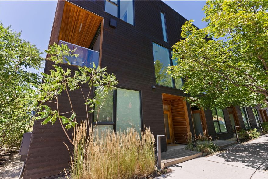 Experience unparalleled urban living at Basecamp: Bend's most coveted modern townhome community with stunning architectural design and a central location like no other for outdoor enthusiasts. Located just one block to the Deschutes River & steps to the Old Mill District & Downtown, this rare END UNIT offers 3BR/3BA PLUS an attached 1BR/1BA ADU. The light-filled Great Room features floor-to-ceiling windows, warm wood accents, gas fireplace and access to private covered deck. Chef's Kitchen w/sleek quartz countertops, expansive island & stainless appl. Dining area, additional sitting room & full BA on main. Upstairs: Primary Suite w/views of the iconic Old Mill smokestacks, spa-like bath & walk-in closet. Two additional BR, full BA, & loft flex space. 422 SF ADU w/full kitchen, full BA and private entrance is an ideal income generator or home office. Oversized 2 car garage for all your Bend gear. Charming outdoor community gathering space with fire pit & grill area to enjoy year-round.