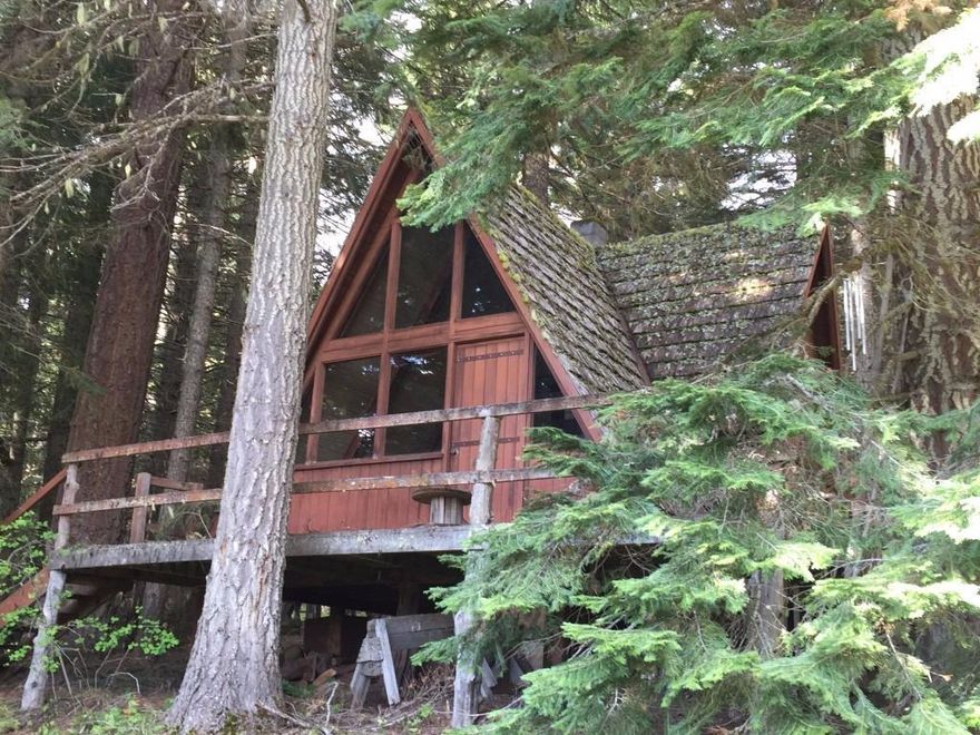 Diamond in the rough - This 68+ acre parcel is situated in the high mountain lake area about a half hour drive from Ashland, Oregon. It sits less than a mile from Howard Prairie Lake. Nestled in a mature forest is a Rustic but functional A-frame cabin. This cabin is a legally recognized structure, built prior to zoning laws. The property is fully off grid and uses spring water gravity fed to the cabin. There are significant volumes of Merchantable Timber, including scattered old growth trees. This property has been used as a family retreat for over 50 years and the Sellers would be very happy to see that tradition continue with the next owner. A Pond, natural meadows, Views of Mt. Mclaughlin and Howard Prairie Lake, are other amenities worth mentioning. Buyer shall rely on their own research regarding property attributes and allowable uses of this property including Home-site suitability and timber.