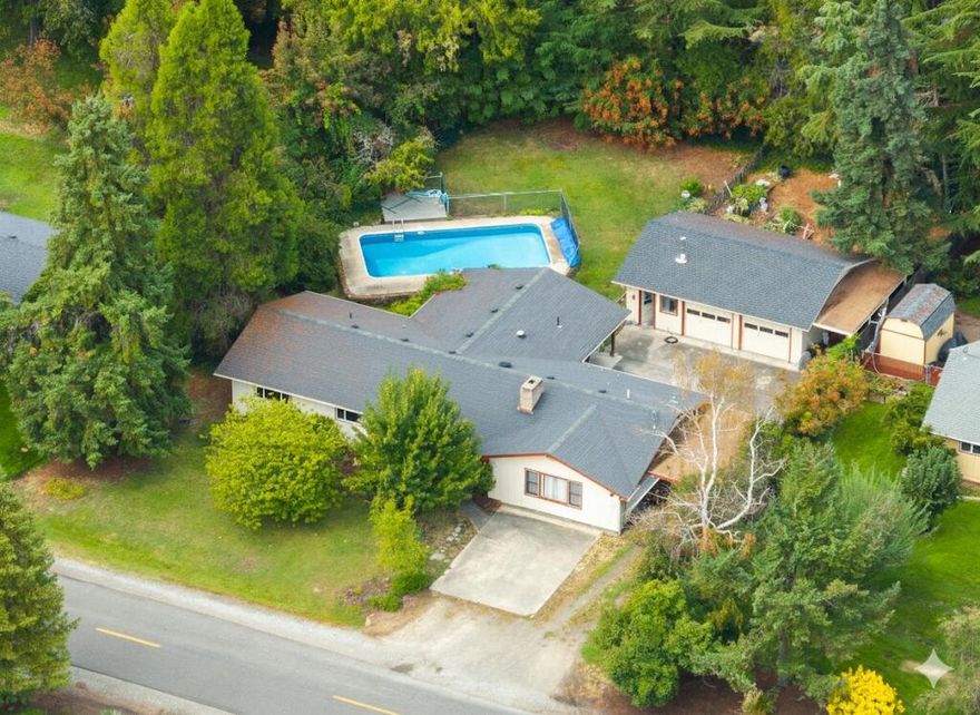 Dream mid-century ranch home on nearly 1/2 acre! This spacious 4BR blends timeless design with modern comforts, featuring a sparkling in-ground pool, oversized detached 2-bay garage with workshop space, and private, mature landscaping. Perfect for entertaining with a covered patio overlooking the pool, raised garden beds for gardening enthusiasts, and an expansive yard for kids and pets. Inside, you'll find classic charm with gleaming hardwood floors, diamond-pane windows, and a cozy wood stove for winter evenings. The chef's kitchen boasts granite counters, abundant cabinetry, a large breakfast bar, plus room for dining and gathering.  Updated bathrooms, a functional laundry room, and tons of storage throughout. The oversized primary suite offers double closets, abundant natural light, plus a private entrance and full bath—currently used as an income-producing Airbnb but ideal for guests, in-laws, or a home office. Prime location just minutes from schools, parks, and shopping/dining.