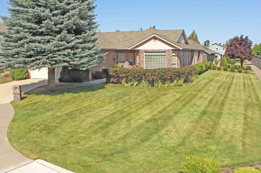 PRICE REDUCED!!! A lovely single level home on a .22 acre corner fence lot. Walk into the bricked-surround rose garden approaching the front door. An open floorplan plus formal living room with bay style windows. Vaulted ceilings/ Center hinge atrium French Style doors to a lovely partially covered patio.  Oak Tree is only a minute from medical services, hospital, restaurants, grocery stores. Sidewalks allow for safe walking & added curb appeal. Includes Refrigerator, built in Microwave. Granite countertops & hardwood flooring in a nicely laid out kitchen with breakfast bar. You'll love the gas fireplace for cozy times in those chilly evenings. The primary bedroom boasts a walk in closet, jetted soaking tub with glass tiles, tiled shower & two sinks. Some of the great features of this home include skylights, utility sink, finished garage, alarm system, storage shed & a newly installed gas furnace.