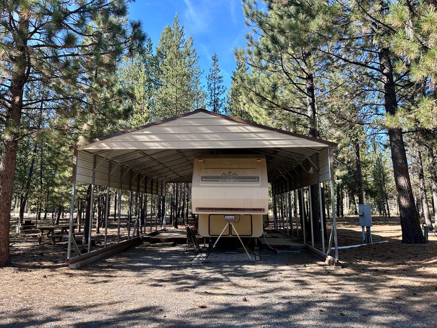 Ready to build or simply enjoy! This 1.70-acre, flat, treed property offers privacy, security, and convenience just minutes from downtown La Pine. Improvements include a 24'x40' metal RV/carport with 12' eaves, power at two locations, a metal storage shed, and multiple freeze-proof faucets. The property features a standard septic system with a oversized 1,500-gallon tank, three RV dump sites, and a private well—everything in place for your build or getaway. A clean 1990 King of the Road 34' RV with one slide is included. The gated entrance, enclosed dog kennel, and level layout make this property both functional and welcoming. Located just off a paved road near the scenic Little Deschutes River—perfect for fishing, kayaking, or peaceful walks. No HOA and close to Hwy 97, shopping, dining, and recreation. Easy access to La Pine State Park, Sunriver, Bend, and Mt. Bachelor. A ready-to-enjoy retreat or the perfect homesite—call today for a private showing!