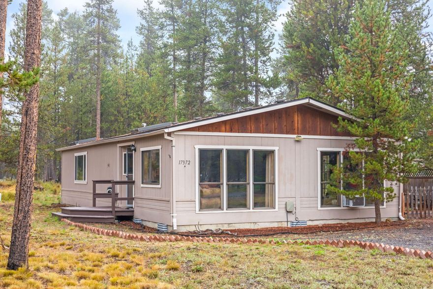 Tucked among the pines on a peaceful half-acre in Oregon Water Wonderland, this 2 bed, 2 bath home blends comfort with Central Oregon adventure. Vaulted ceilings and south-facing windows brighten the great room, while a cozy wood-burning stove creates warmth and charm. The main-level primary suite and spacious second bedroom offer flexible living. Outside, enjoy a forested setting with a private patio, storage sheds, and space for a future garage or shop. Updates include a newer roof (2015/16), Bosch ultra-quiet dishwasher, SS refrigerator, and high-speed fiber. Located on a paved street with OWW public water/sewer, plus minutes from the neighborhood boat launch, park, and private Deschutes River access. Just 20 minutes to Bend, Cascade Lakes Highway, Mt. Bachelor, and the Three Sisters Wilderness. Ideal for full-time living, a vacation retreat, or potential short-term rental!