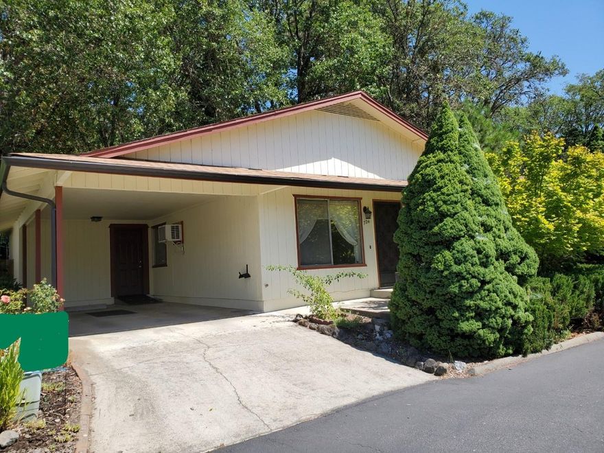 Delightful home in 55+ community! 3 bedroom or 2 bedroom and den/office/craft room. Kitchen with tile floor and pantry. Large living room with laminate flooring. Dining area with laminate flooring. Laundry closet and linen closet. Delightful front porch area with Dogwood and Maple tree. Carport with easy access to kitchen for those groceries. HOA includes use of pool, clubhouse, water, sewer and gated RV parking. Owner holds an active Oregon real estate license.