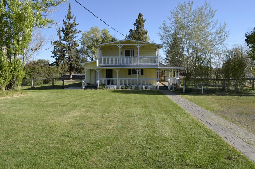 Bring your animals, room to roam on 4.78 acres!  Hard to find close in acreage. Very private mature landscaping, set up with fenced yard and pasture.  Irrigation water rights
from COID for 3 acres.  New 36 x 60 steel barn in 2018 with reinforced concrete floor. There is a separate rustic
chicken coop and two single sized detached garages. 30 x 60 heated shop with a bathroom and office space. Home features farmhouse style covered porch,
large living room with pellet stove, hardwood floors, mud room/laundry room with separate entrance and bathroom.  Upstairs master bedroom has a private
covered porch to enjoy. There is a basement with a closet for additional space.  Come and tour this spacious farm property, just minutes from town.