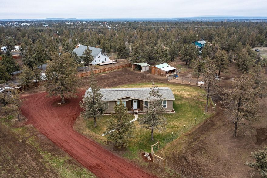 Welcome to the beautiful Crook River Ranch retreat with an abundance of amenities! Discover a newer home with 3 bedrooms, 2.5 bathrooms, an open floor plan, and an office, perfect for those craving space and comfort. The large kitchen boasts ample storage, while laminate flooring and plush carpeting add a touch of luxury. The private primary bedroom features a walk-in shower and a spacious closet, creating a haven within your home. Situated on 2.3 acres, this property is a horse lover's paradise with fenced and crossed fencing, a chicken coop, and a newly built tack shed with a 2-stall lean-to.Enjoy the outdoors with a raised garden bed and modern convenience with a new septic tank. The gated
entry ensures security, and there's plenty of room for a future shop or barn. This property offers a blend of comfort, convenience, and potential for a discerning buyer. Live amidst nature's beauty with equestrian amenities and endless possibilities in this charming home.