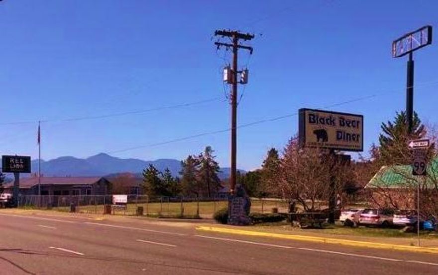 Opportunity to build your own on US Hwy 99 one block from I-5 Exit 58! Once the location of a popular gas station/ mini mart, this flat .49 ac lot zoned General Commercial has a clean bill of health from DEQ and is ready to go as a blank-slate lot with the utilities stubbed in.  Dedicated driveway off Hwy 99/NW 6th Street as well as access through neighboring property with deeded easement. JCT bus stop at SE corner. Large sign pole on property can be seen from both North & South bound Interstate traffic. Surrounded by hotels, restaurants & fast food, gas stations with the Visitor's Center a block away. City views could be maximized with vertical build. City of Grants Pass has previously approved (3) 1800 sq ft buildings; a used car dealership; a drive-thru; a 12 cart foodcart pod. High potential for 'stacking', high traffic count, visibility, & flow. Buyer to conduct own due diligence as to the approved uses with City of Grants Pass. See documents for DEQ, maps, etc