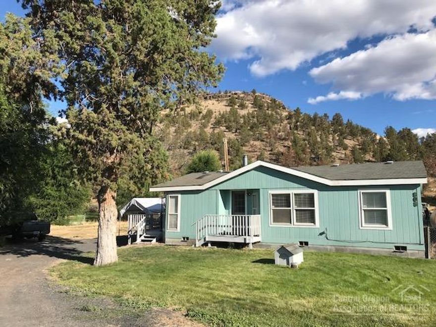 .41 acre lot close to town. 3 bed 2 bath 1063 sq ft home. Freshly painted, home includes Range, Refrigerator, monitor heater, electric FA furnace, laminate flooring and carpet. Detached single garage and carport. Private well, plenty of room for RV parking and room for a garden. Lean-to for storage.