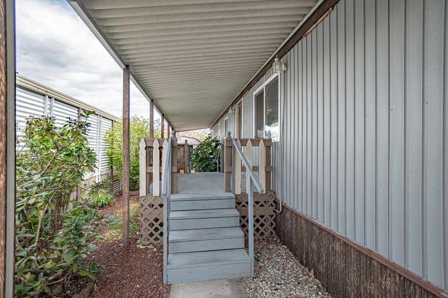 Discover your perfect retreat in the desired Rogue Lea 55+ park, this nicely remodeled and updated single wide manufactured home is nestled in a serene park setting complete with picturesque ponds and convenient river access. This home has new natural stone countertops, luxury vinyl flooring throughout, new windows, new gas range & fridge, bathrooms complete with new vanities and a new shower. The back yard is well established and room for a small garden. A large carport accommodates plenty of parking. There is an additional 200 square feet added on that is not included in the listed square footage. This park has 3 bass ponds, easy walk to river access, includes a beautiful community club house. Enjoy the tranquility of nature while being just a stone's throw from recreational activities. Don't miss the opportunity to make this peaceful oasis your own.