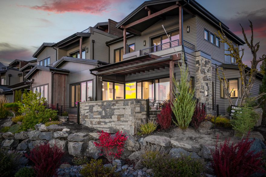 The best of Bend living is at your front door with this incredible townhome on the banks of the Deschutes, overlooking the layered landscape of River Bend park, the Old Mill, and the picturesque white-capped mountains beyond. Here, clean lines and luxurious finishes exude effortless modern ambiance in a functional three story layout. Upon entering you will find a stunning indoor outdoor living concept, with no detail left untouched. This home features stained oak wood flooring throughout, Harvest Moon Woodworks custom made kitchen cabinets, and seamless high glass range hood, complete with 4mm waterfall quartz kitchen island. A floating staircase of steel construction and oak steps connect the three stories, with under mount lighting through the second and third levels. On the third level, escape to a perfect entertaining space, with a wet bar, covered outdoor patio with stunning rooftop views. When it comes to the Central Oregon lifestyle, truly nothing compares.